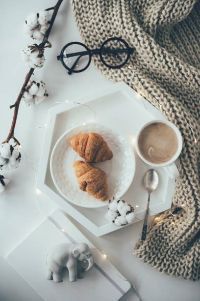 istock Cozy home breakfast, warm blanket, coffee and croissant on white 926786442