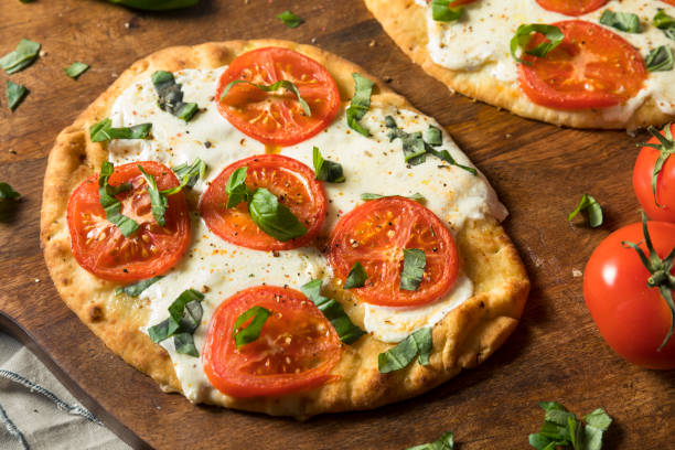 Mozarella Basil and Tomato Flatbread PIzza Mozarella Basil and Tomato Flatbread PIzza on Naan Bread flatbread stock pictures, royalty-free photos & images