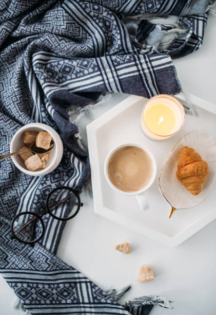 istock Cozy home breakfast, warm blanket, coffee and croissant on white 926788740