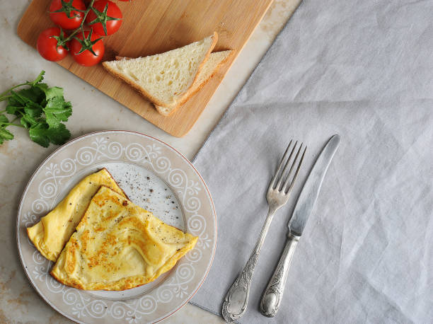 omelette on a plate, parsley, tomatoes, toast