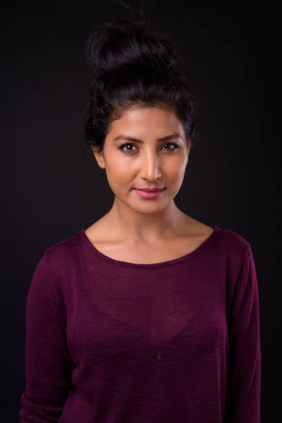 istock Young beautiful Indian woman against black background 926797004