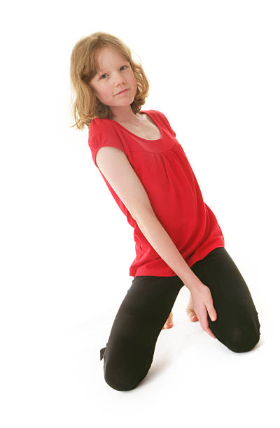 Beautiful teen wearing red shirt and red shoes and smiling