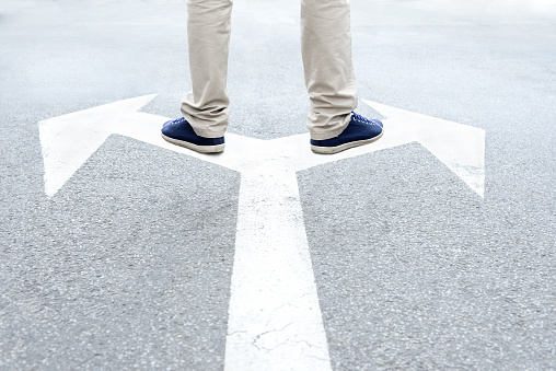 A top view of a big yellow traffic arrow right sign painted on a concrete ground outdoors