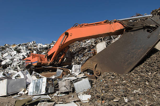 istock Scrapyard For Old Household Goods With Partially Buried Excavator 92680480