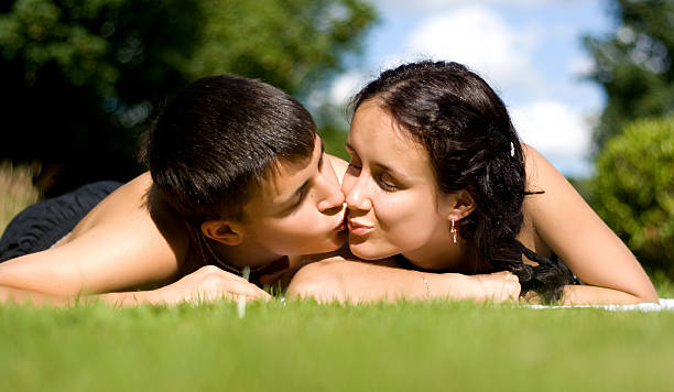 Happy couple lying on grass. stock photo