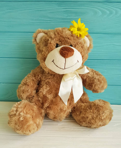 istock bear toy wooden flower background 926806198