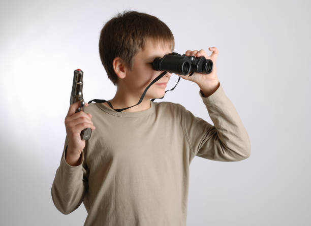 istock Child with gun and look-see on light background 92680736