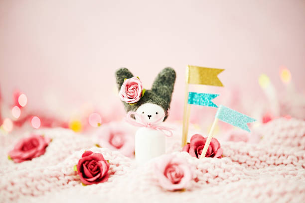 Handmade Easter bunny with holiday flags and flowers
