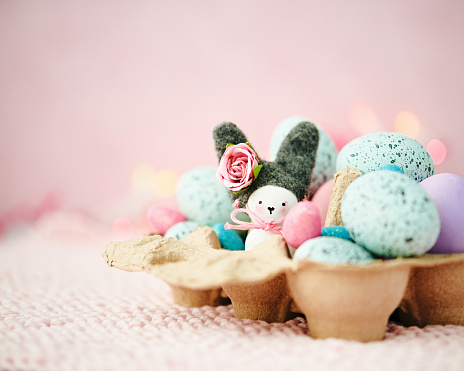 Handmade Easter bunny in cardboard egg carton with Easter eggs 