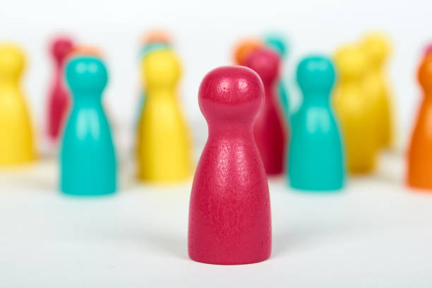 Wooden pawn leisure game figures. Isolated on white background, social idea, immigrants problem. Togetherness