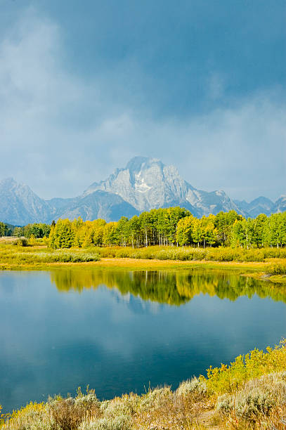 istock mountains, sky and fall colors reflected in lake 92681168