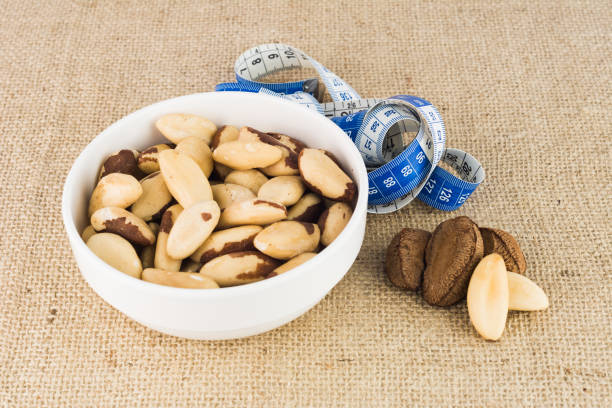 brazil nuts (bertholletia excelsa), typical product from amazon rainforest - textile healthy eating instrument of measurement tape measure imagens e fotografias de stock