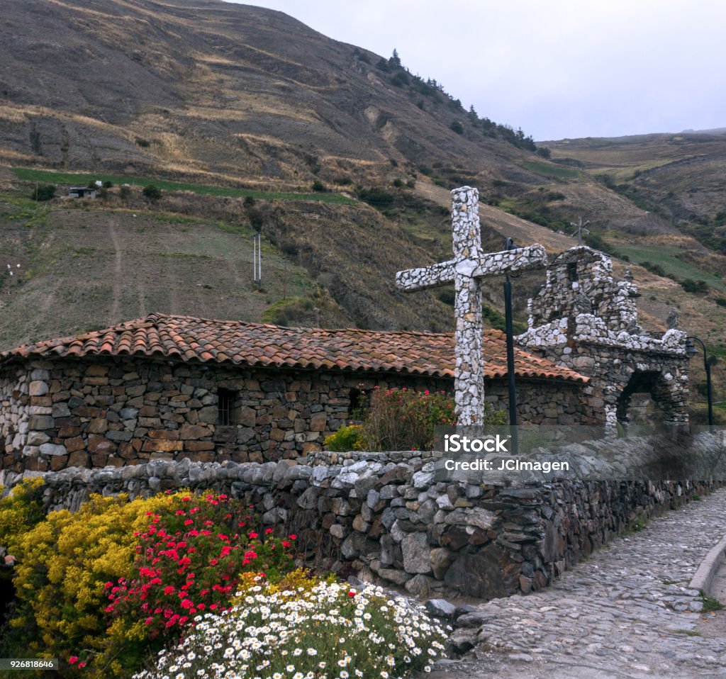 stone cross andes of Merida Venezuela Stone cross surrounded by flowers of the garden, mountains and peaks of the Venezuelan Andes.  Venezuela Stock Photo