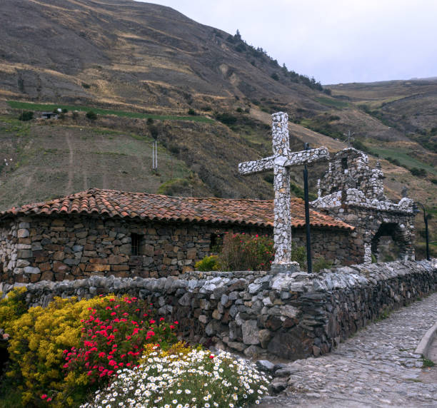 stone cross andes of Merida Venezuela Stone cross surrounded by flowers of the garden, mountains and peaks of the Venezuelan Andes.  venezuela stock pictures, royalty-free photos & images