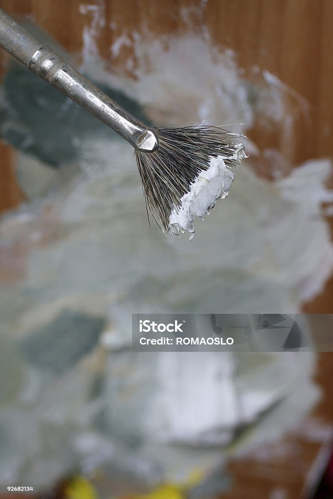 Paintbrush with white oil color Painting brush with white oil paints over a palette-shallow DOF focus on the white paint Abstract Stock Photo