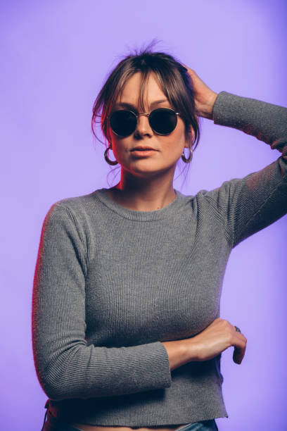 istock Happy young woman on a purple background 926828920
