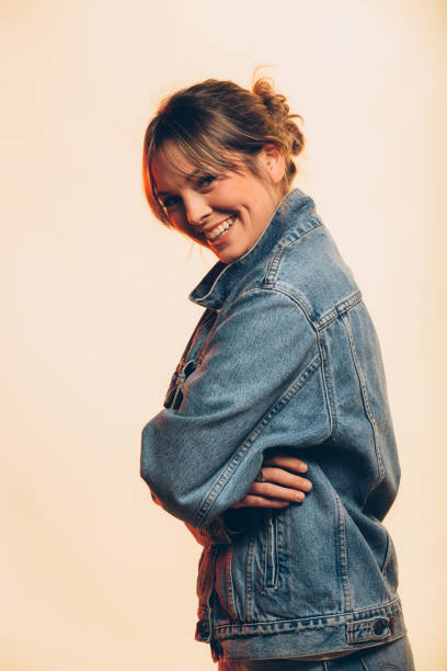 istock Happy young woman smiling and posing on a beige background 926829130