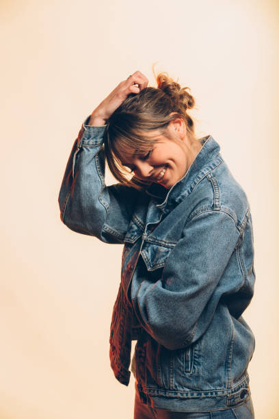 istock Happy young woman smiling and posing on a beige background 926829284