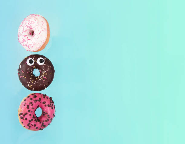 istock Colorful glazed donuts in motion with funny eyes 926836864