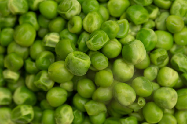 Steaming Hot Peas on a Wooden Table