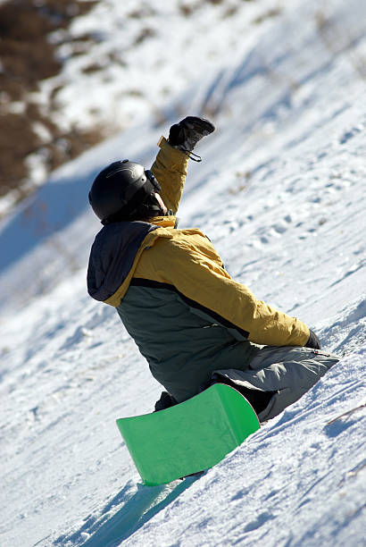 istock Snowboarder sits on slope in expectation of 92685773