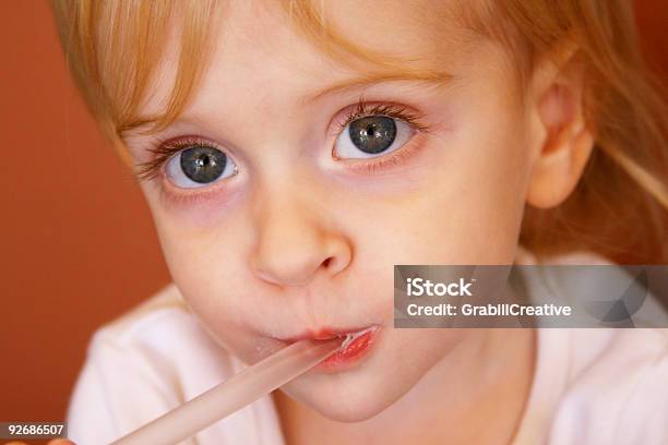 Adorable Toddler Girl Sips Chicolate Milkshake Throug A Straw Stock Photo - Download Image Now