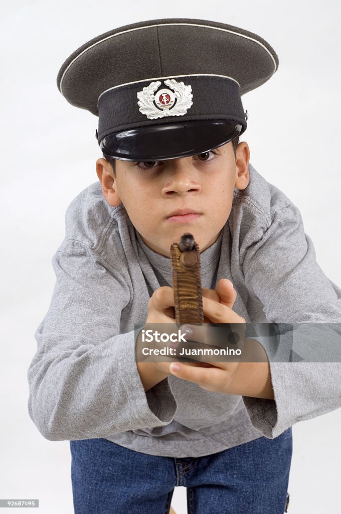 Playing soldier young child playing soldier with an old east germany military hat on white background Boys Stock Photo