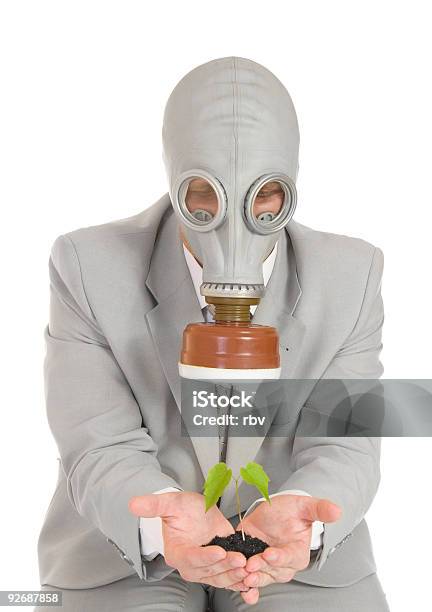 Hombre De La Máscara De Gas Sosteniendo Planta Verde Foto de stock y más banco de imágenes de Adulto