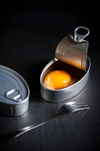 istock Aluminum can with egg yolk inside insulated on black background 926885636
