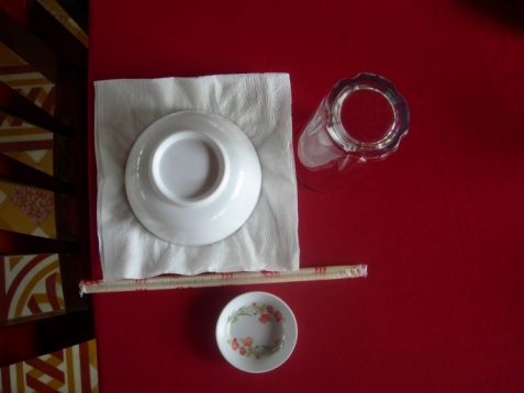 Empty aged white ceramic plate with berry sauce in a gravy boat and cutlery on a white wooden tray. Menu layout for displaying dishes