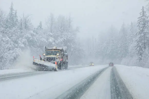 Photo of Snow plow clearing highway during snow storm.