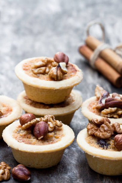 istock mini  ginger and walnut tarts on wooden background 926898952