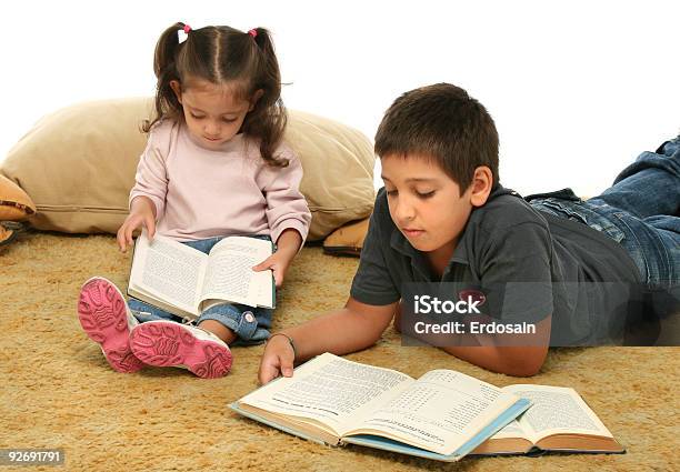 Brother And Sister Reading Books On The Floor Stock Photo - Download Image Now - Book, Boys, Girls