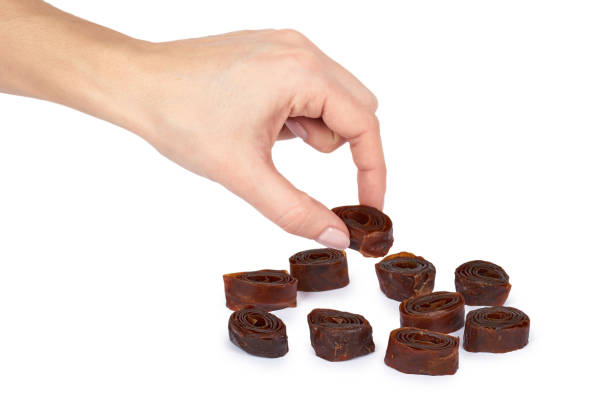 istock Home made apple and plum fruit pastille rolls with hand. Isolated on white background. Healthy kids food and snack, natural ingredients 926918002