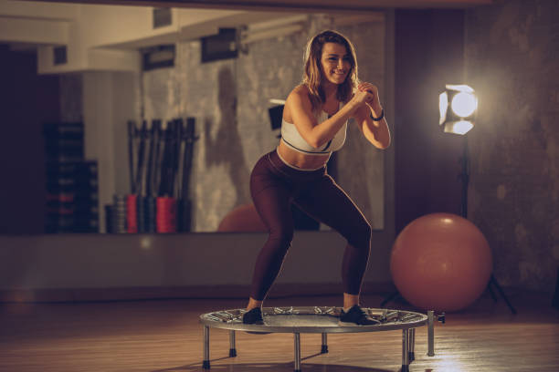 istock Woman exercising on a mini-trampoline at the gym 926921116