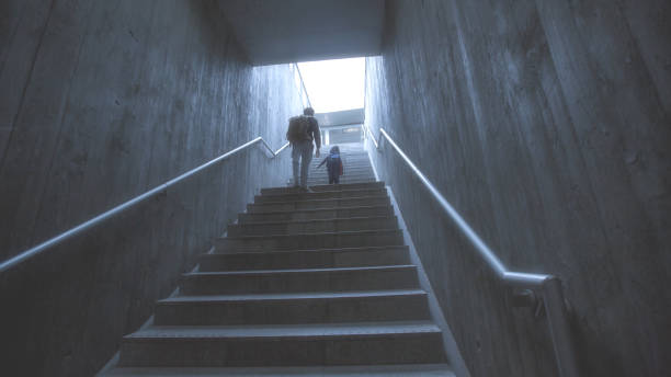 istock father and son climbing stairs in pedestrian subway 926921638