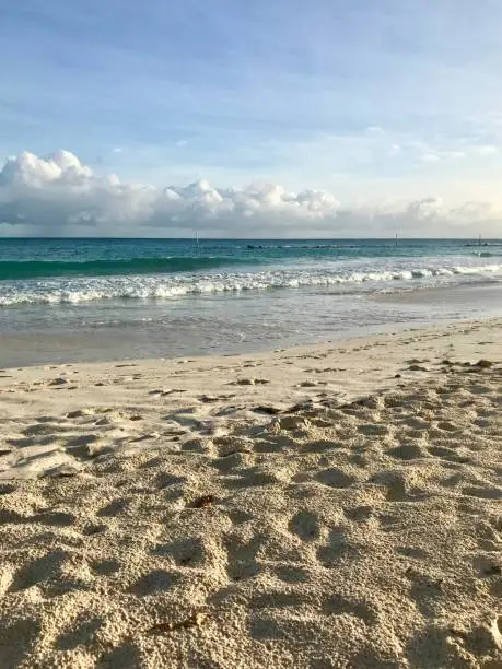Photo of Idyllic and beautiful beach in Barbados (Caribbean island): Nobody, white sand, turquoise water, waves and white clouds