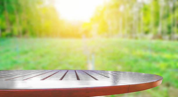 istock Wooden table top with blurred nature background 926934126