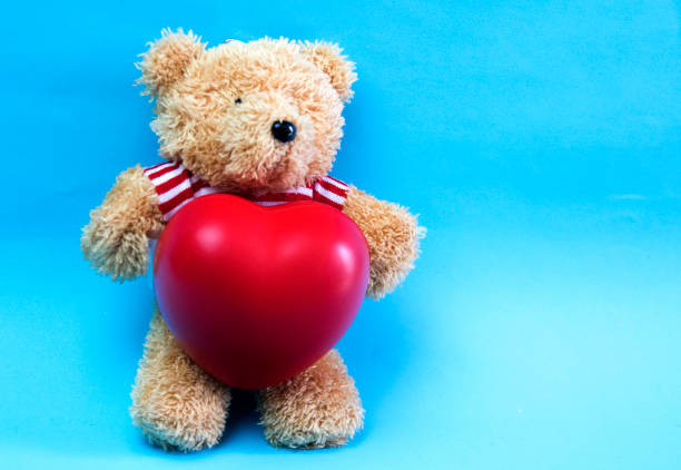 istock Little teddy bear , a valentine's gift for lover isolated on light blue background 926936672