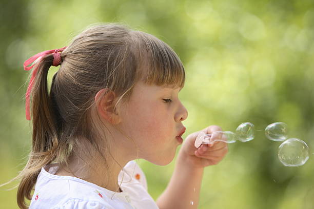 istock Young girl blowing bubbles 92693823