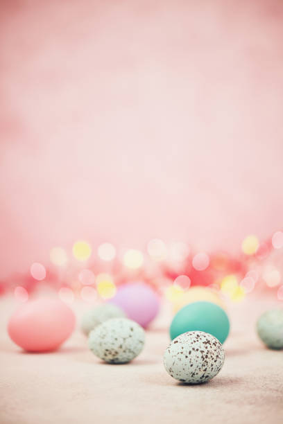 istock Pastel pink bokeh background with pastel eggs for Easter 926943220