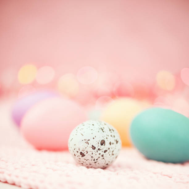 istock Pastel pink bokeh background with pastel eggs for Easter 926943224
