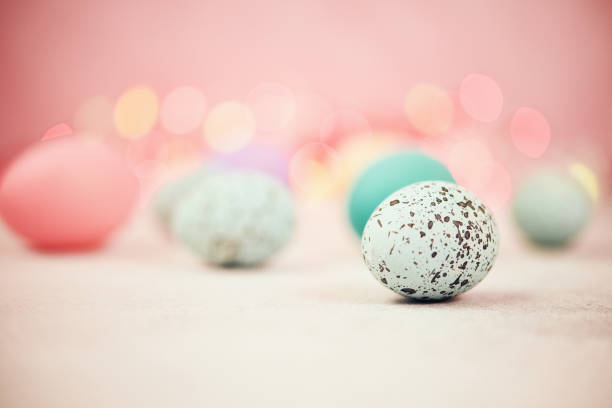 istock Pastel pink bokeh background with pastel eggs for Easter 926943272