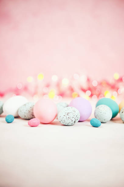 istock Pastel pink bokeh background with pastel eggs for Easter 926943278