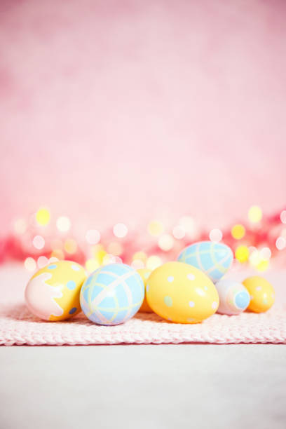 istock Pastel pink bokeh background with yellow and blue eggs for Easter 926943344