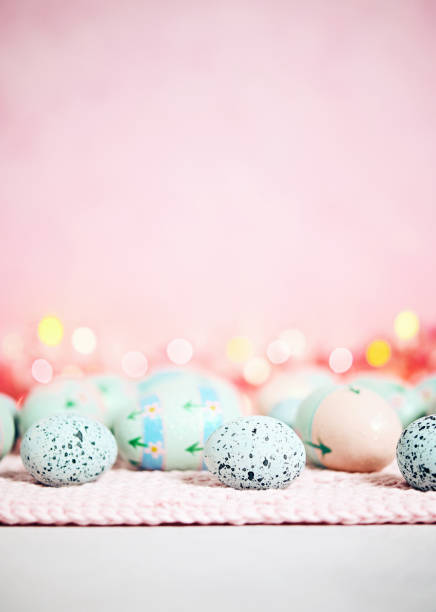 istock Pastel pink bokeh background with pastel eggs for Easter 926943474