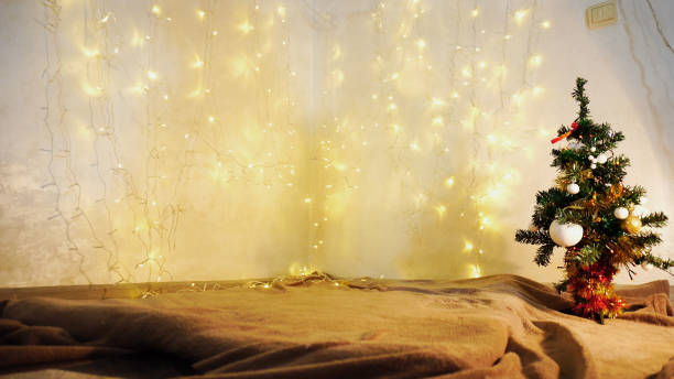 istock Yellow twinkling  garlands and Christmas tre 926943642