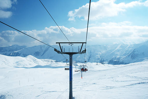 istock Ski lift chairs on bright winter day 92694961