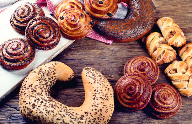 istock Breads,  buns, croissants. Bakery ingredients on wooden background 926953288
