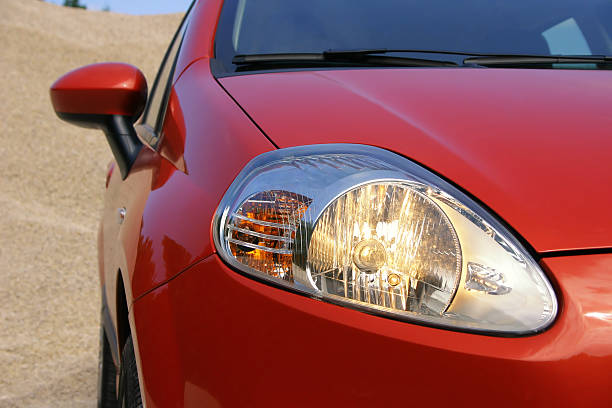Close-up of the driving lights on a red compact car